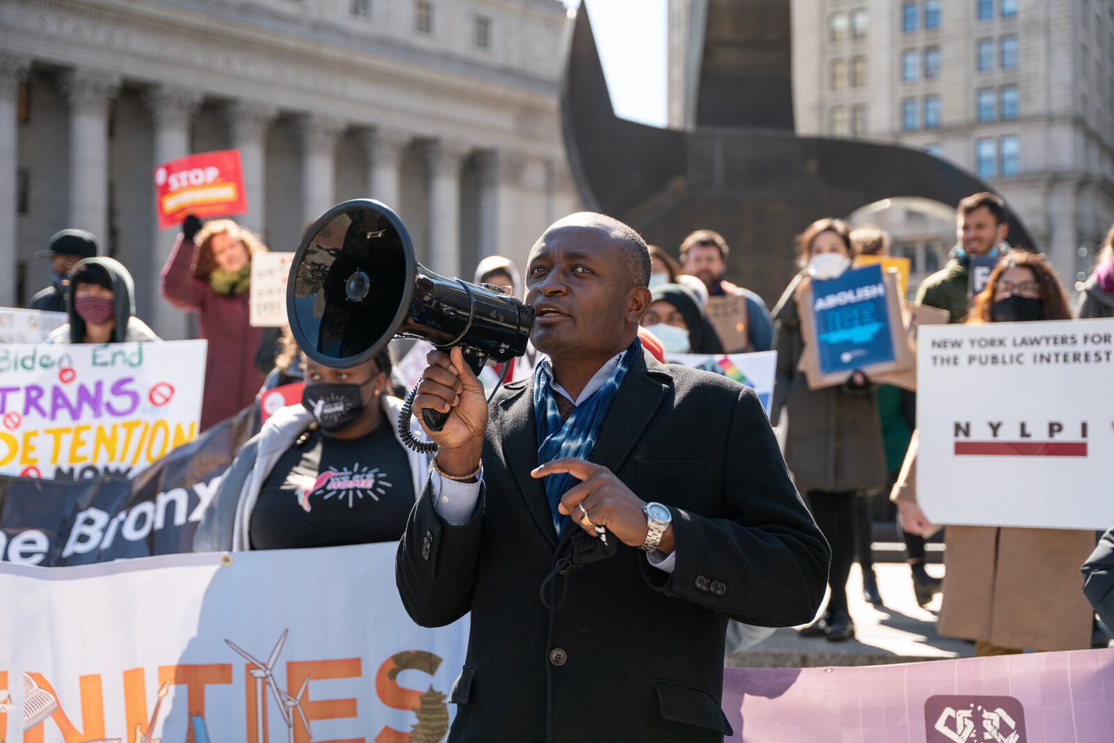 man with megaphone in front of crowd