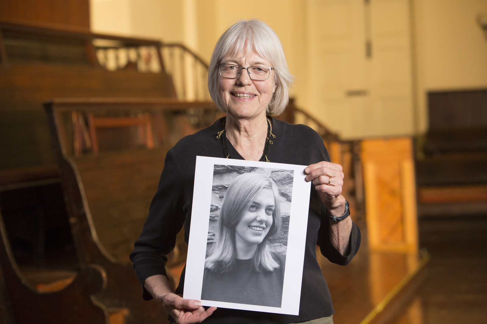 person holding up a photo of their younger self