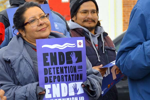 A woman holding a sign reading 