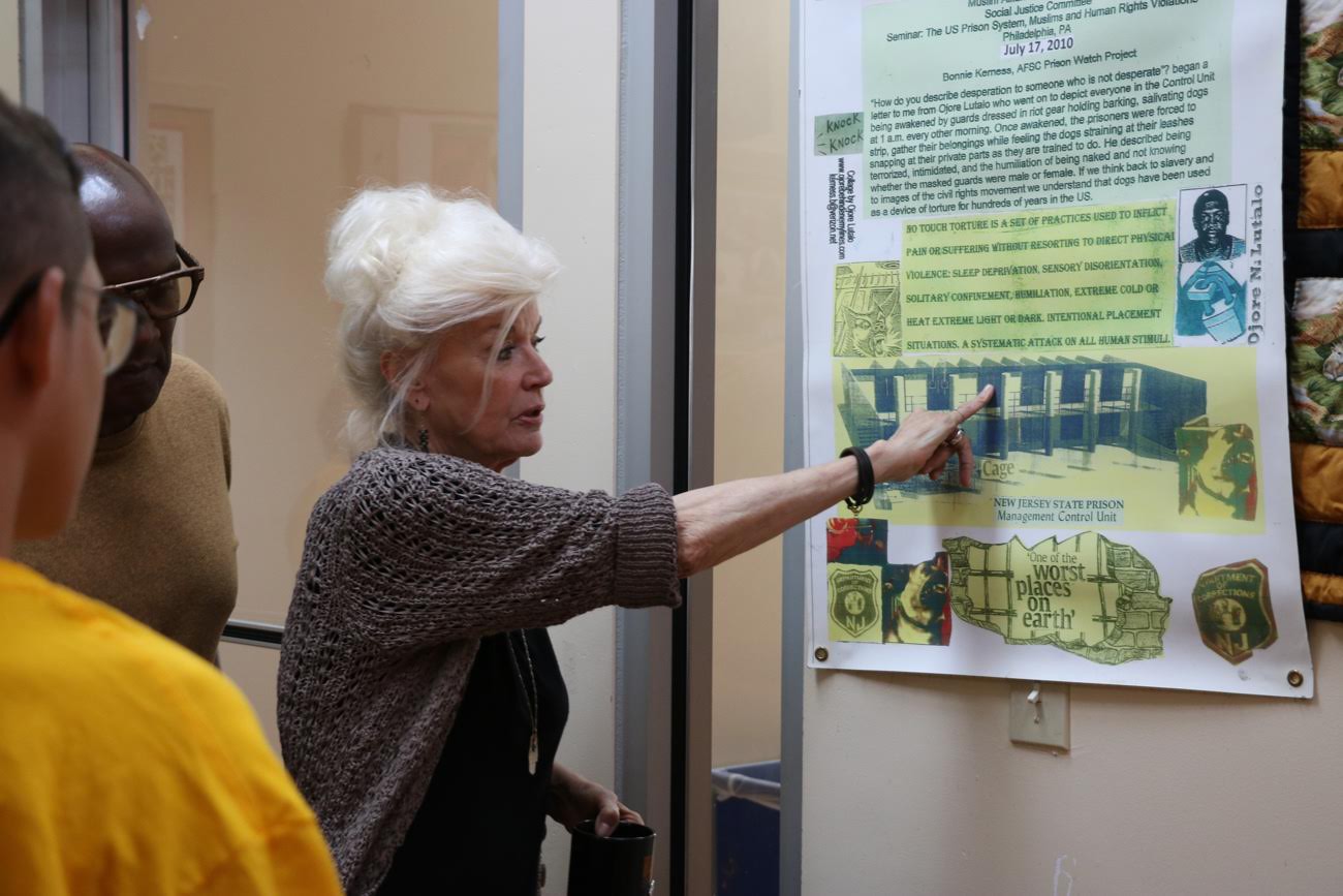 Bonnie celebration, pointing at artwork at liberation summer camp