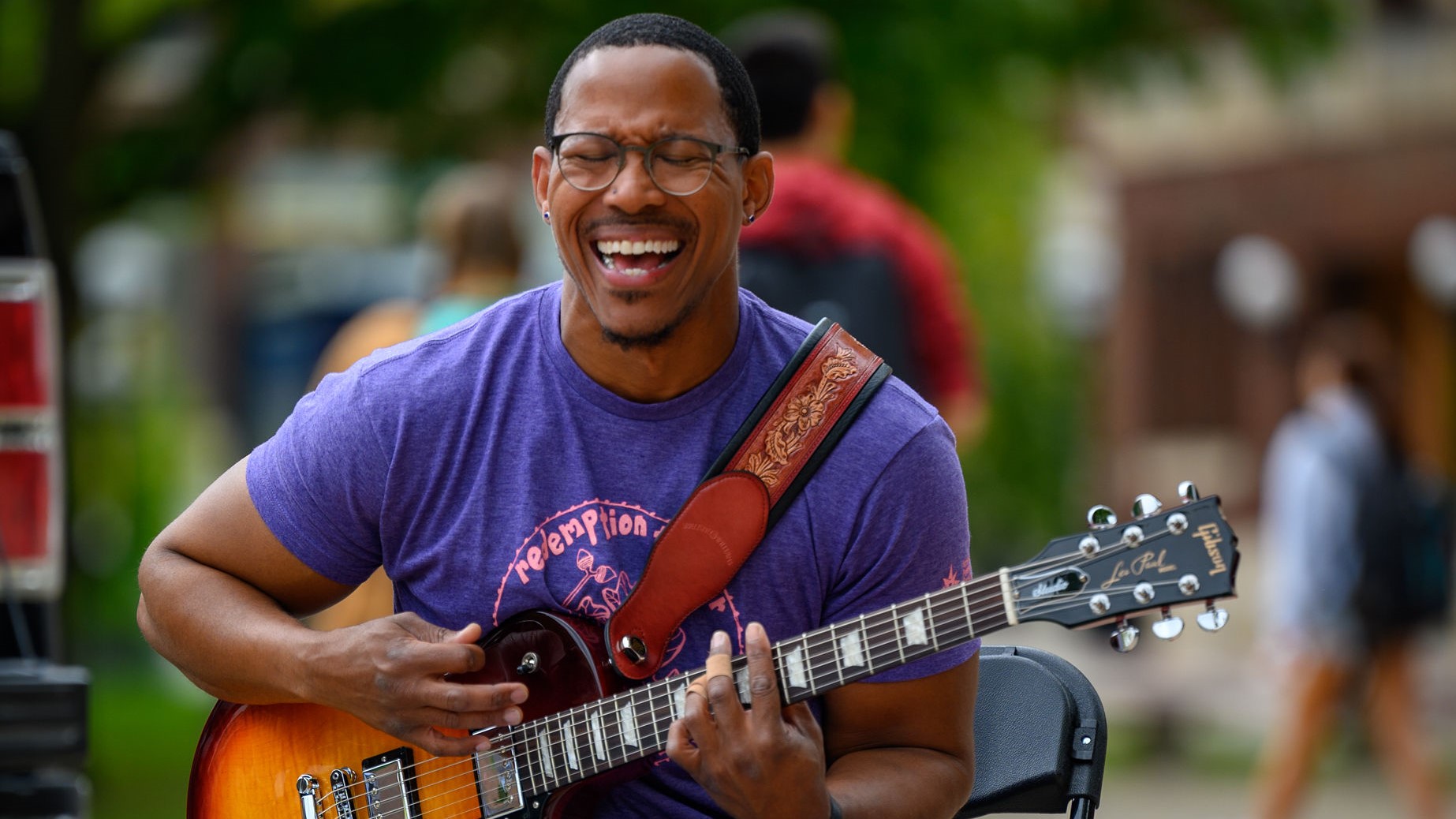 Cozine Welch of AFSC plays guitar