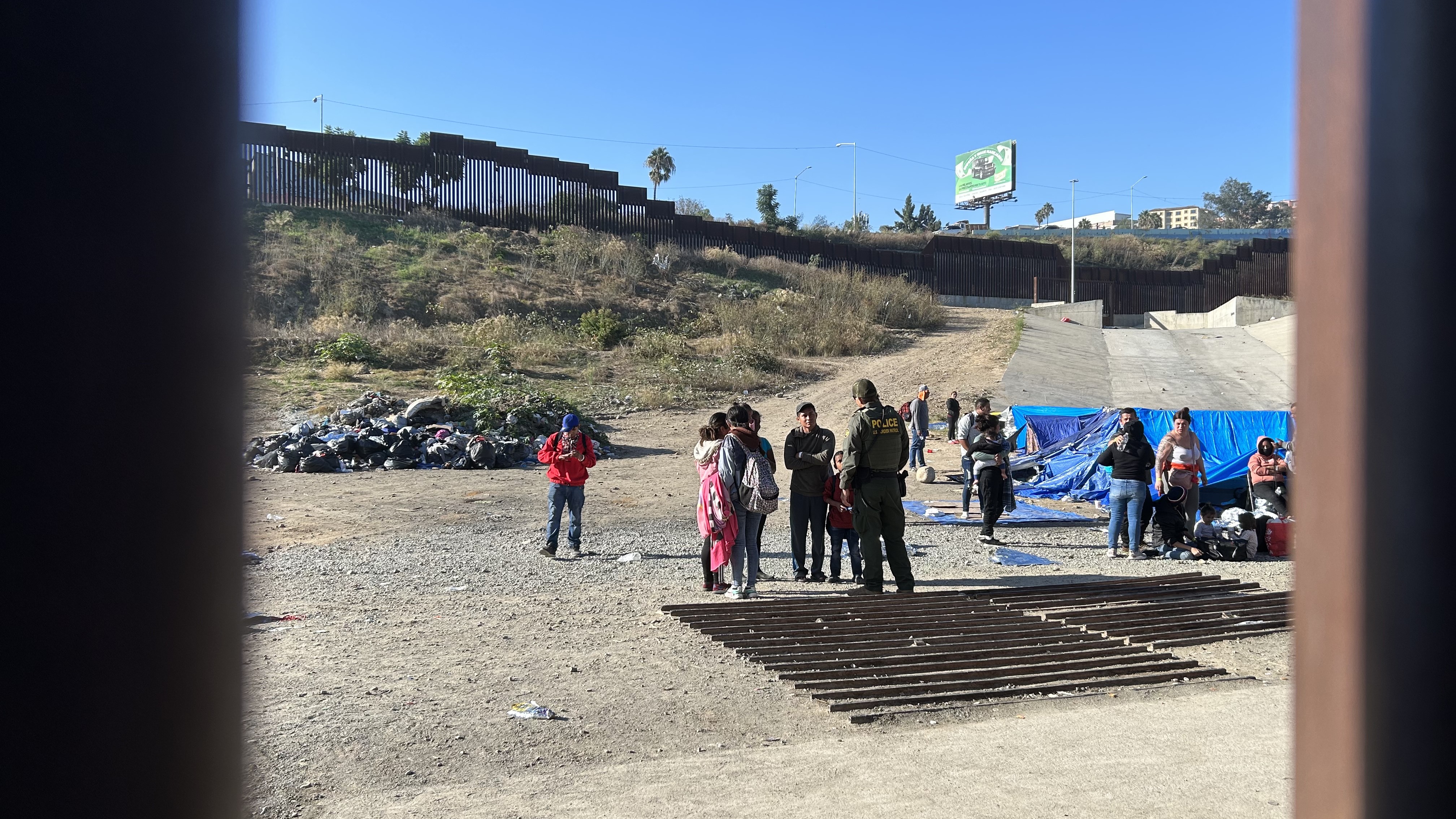 Border Patrol agent questioning migrants