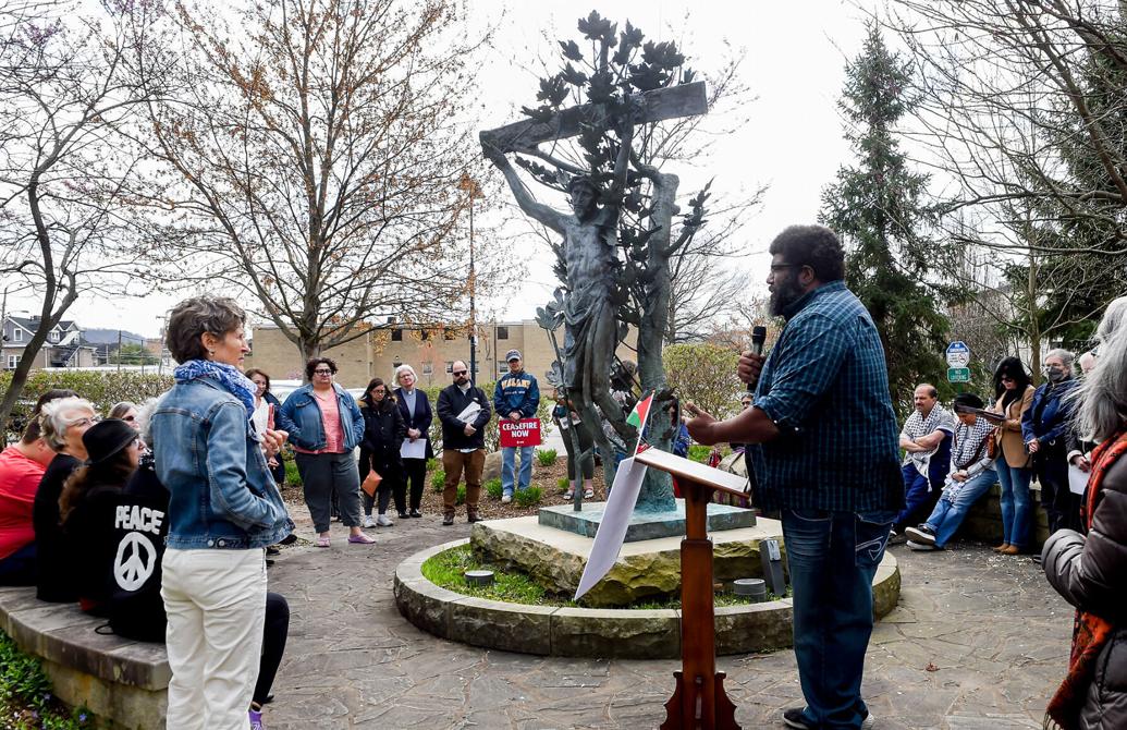 Image of a group of people gathered around a statue