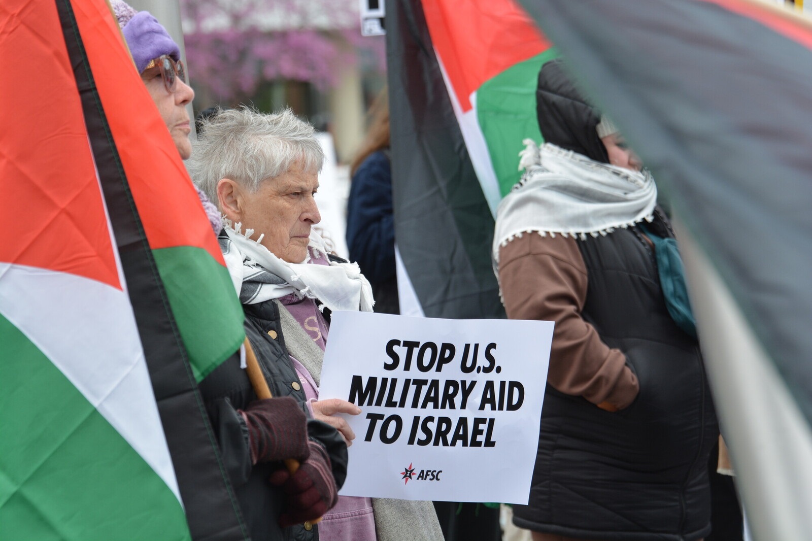 Person holds sign that says 