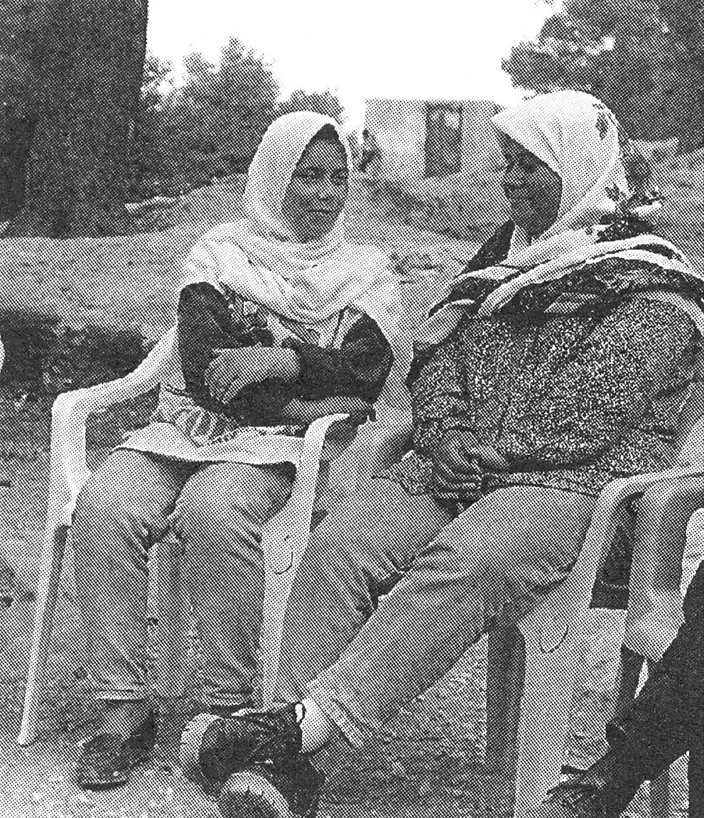 Two youth sitting together outside