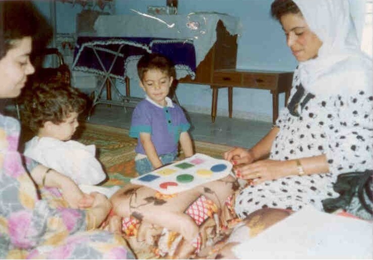 Two children sitting on the floor playing a game