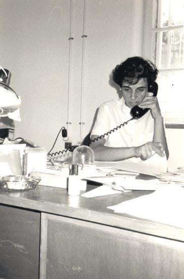 Woman answering a phone at a desk