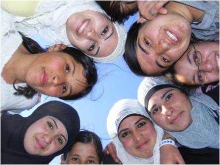 Group of youth standing in a circle looking down into the camera