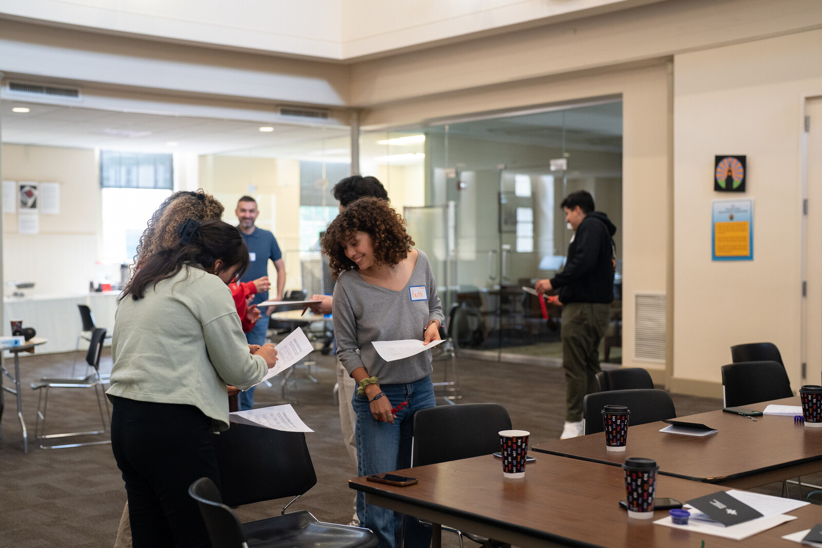 Emerging Leaders for Liberation Fellows look at handouts together