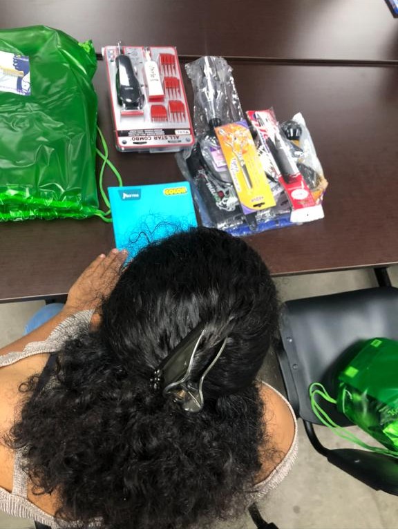 A young woman gets her hair cut.