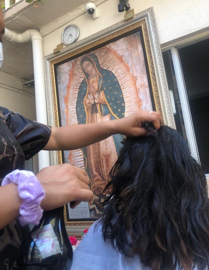 A young woman gets her hair cut.