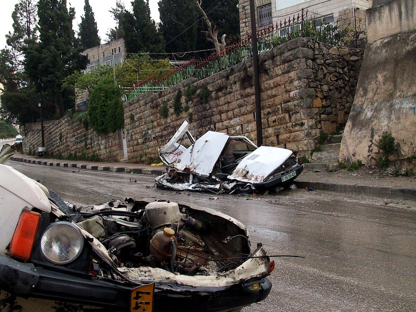 cars squashed by tanks during the incursions.  These cars, as was often the case, were not  blocking the road.  The tanks just ran up the side of the roads destroying cars as they went. Photo by Peter Shafer.